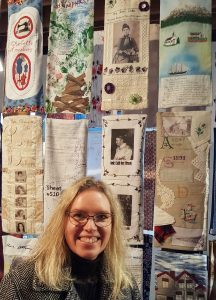 Faye at the Suffrage in Stitches exhibition, Wellington Museum in August 2019.
